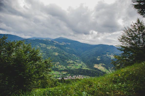 Window view showing the green hills surrounding Pacopampa village.