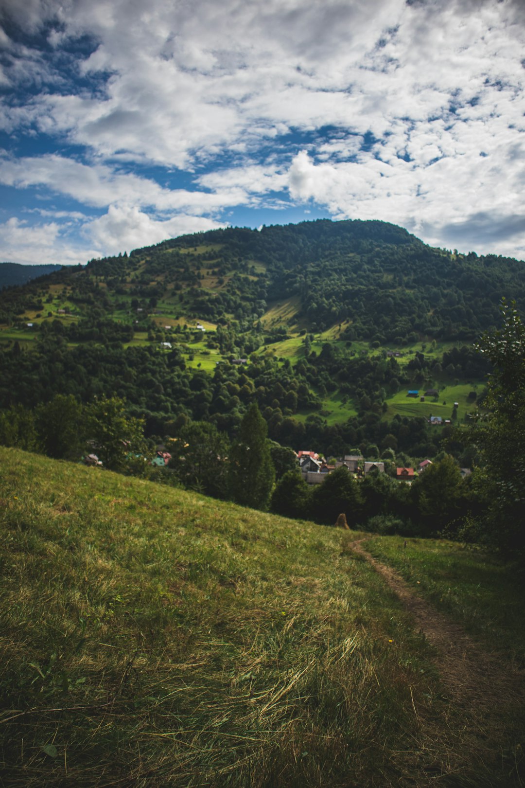 green mountain under white clouds during daytime