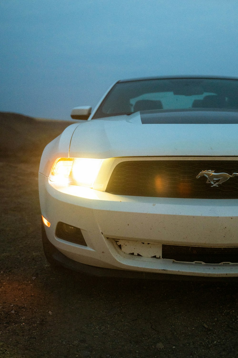 white chevrolet camaro on road during night time