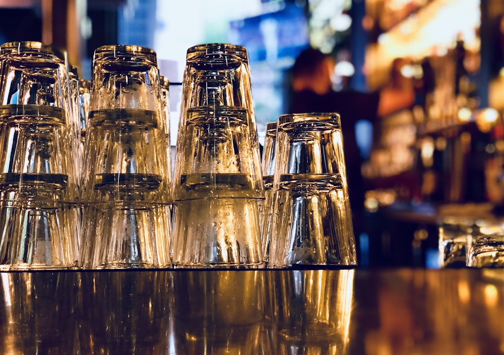 clear glass bottles on brown wooden table