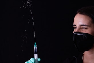 person holding green and black plastic tube