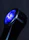 Close-up of a néonvif product glowing with neon cyan highlights on a sleek black surface