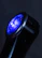 Vibrant image of Caliburn G3 pod with neon blue and green highlights on charcoal surface.