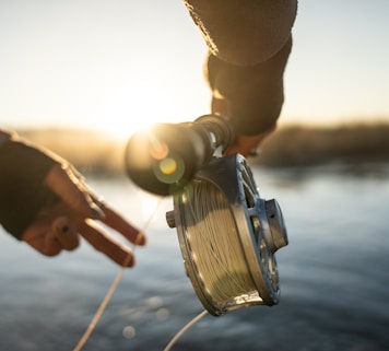 person holding fishing rod with reel