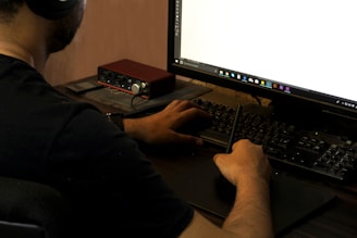 person in black long sleeve shirt using computer