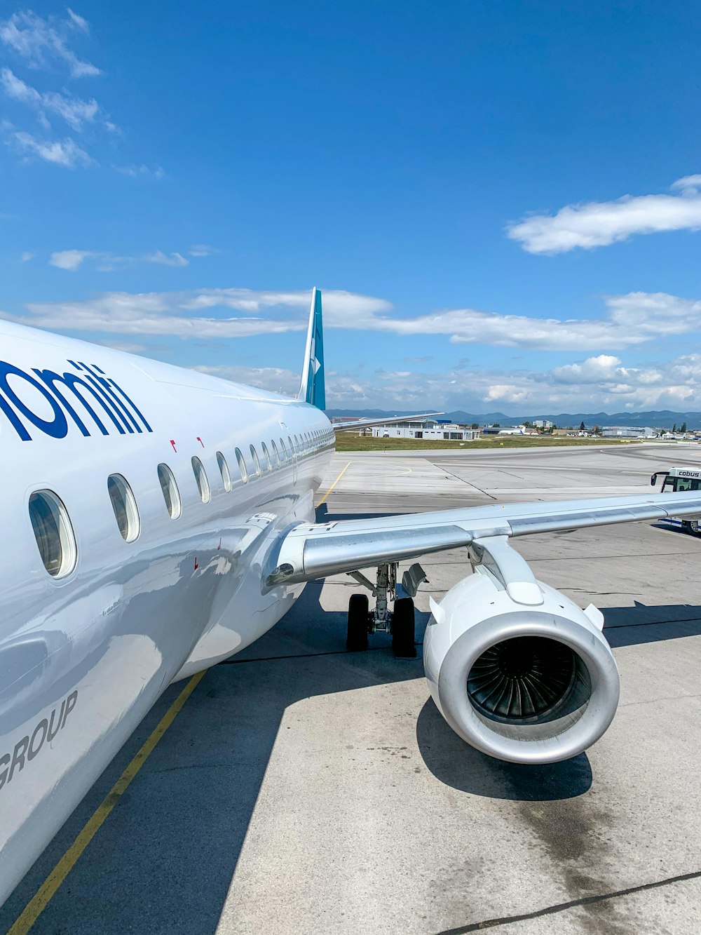 white and blue airplane under blue sky during daytime