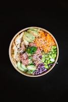 A vibrant poke bowl bursting with colorful island ingredients and a sprinkle of za'atar.