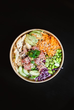 A cheerful family preparing colorful poke bowls together in a cozy kitchen.