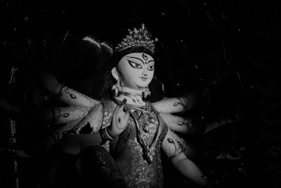 Close-up of the serene Kubera posture of the Vishnumaya deity with two hands.