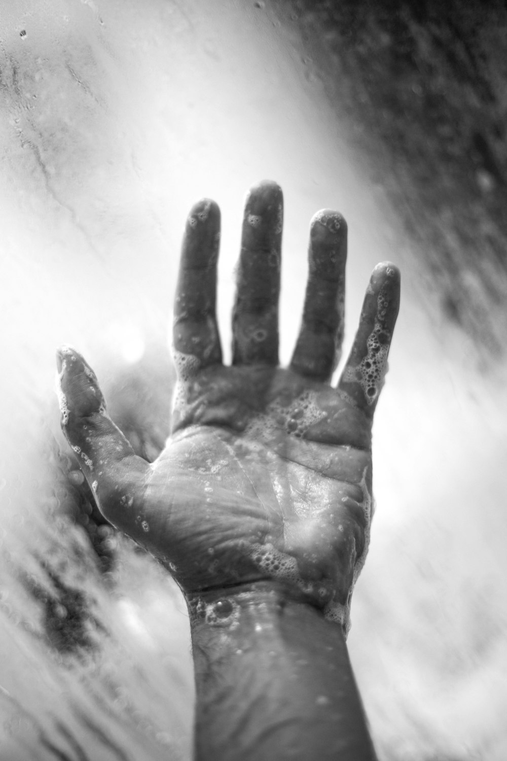 grayscale photo of persons hand