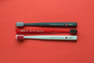 silver and red metal rod