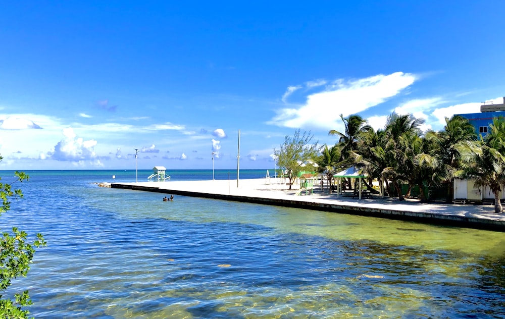 white and blue boat on blue sea under blue sky during daytime