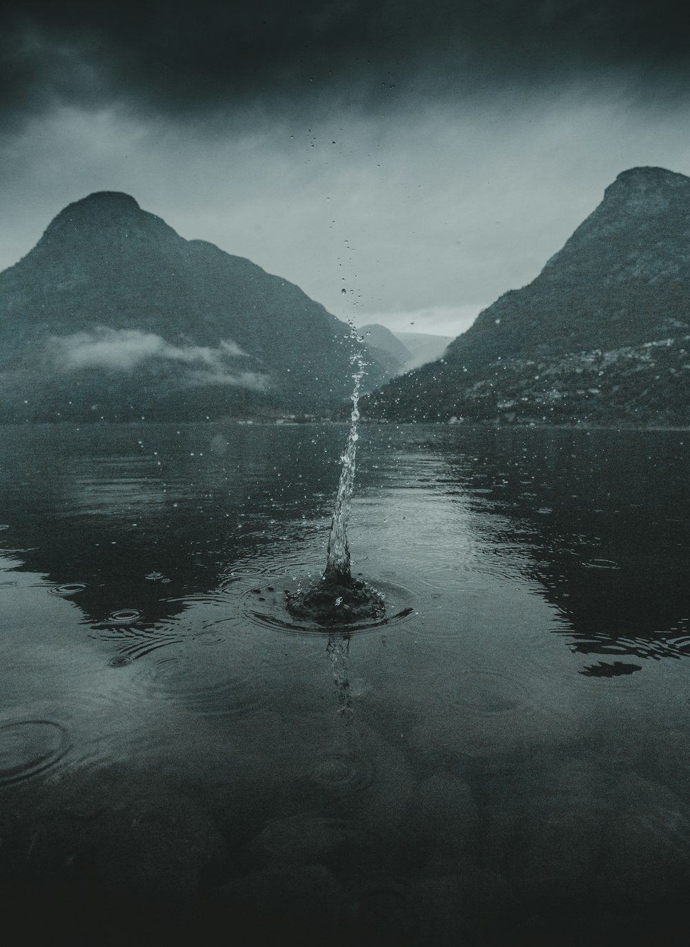 water fountain in the middle of lake