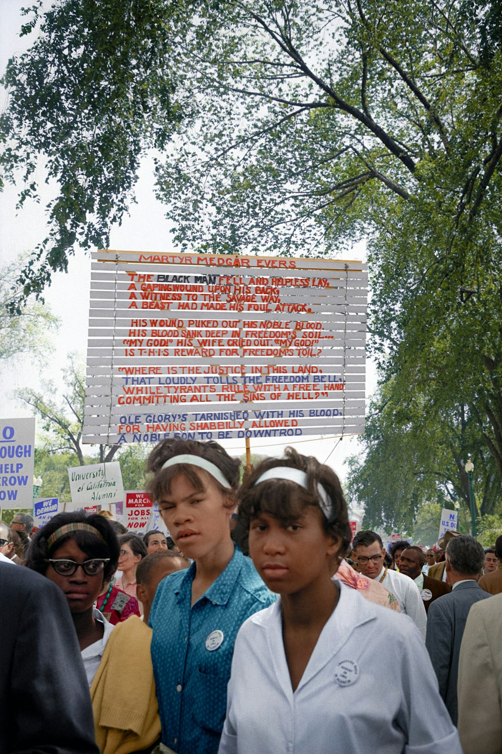 Young African Americon women with signs raised behind them at the March on Washington, 1963