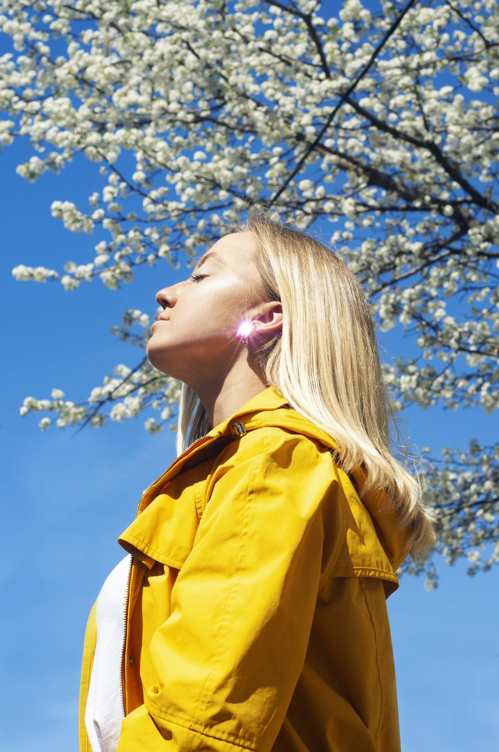 woman in yellow jacket under white and blue cloudy sky during daytime