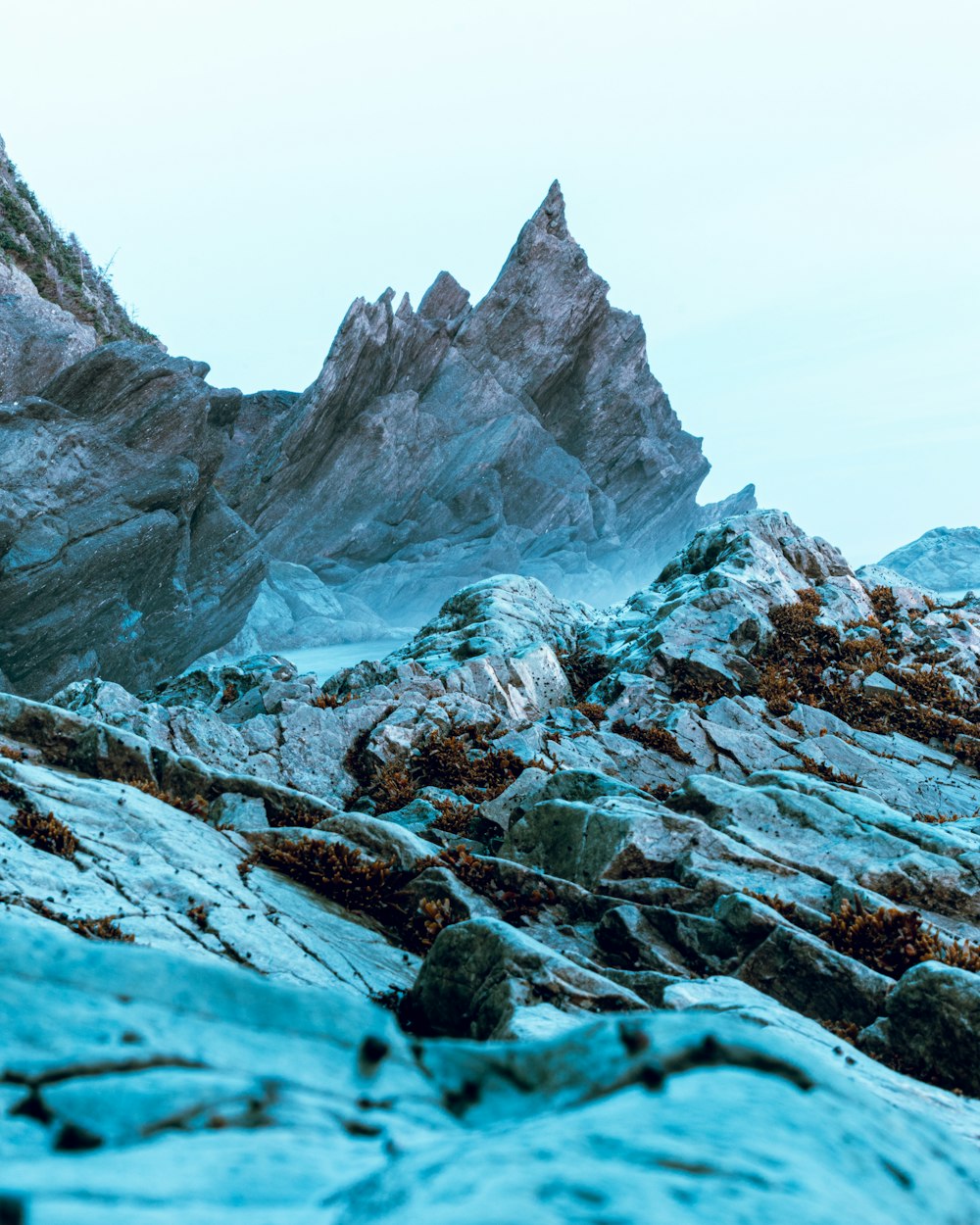 gray and white rock formation under white sky during daytime