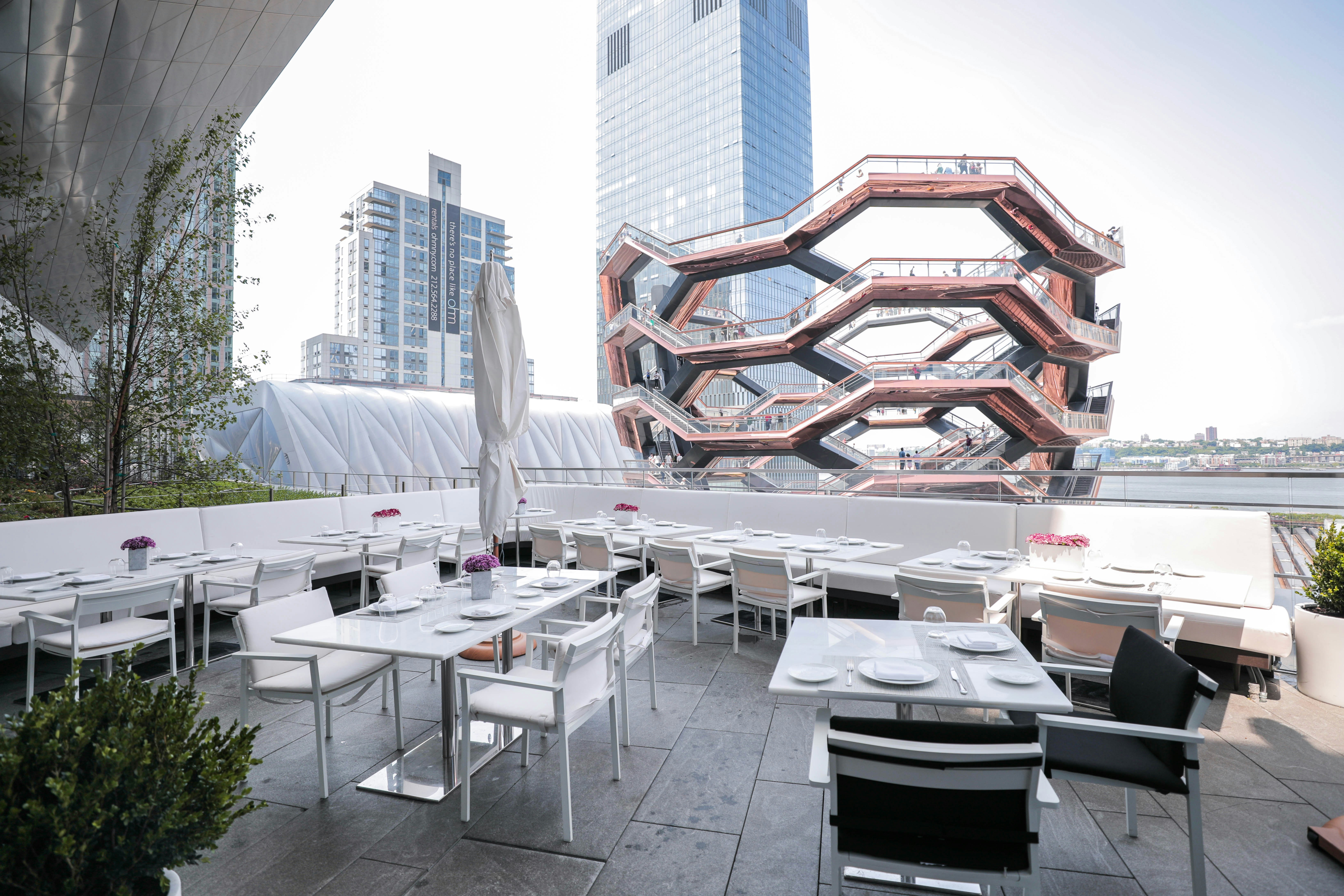 white table and chairs near brown building during daytime