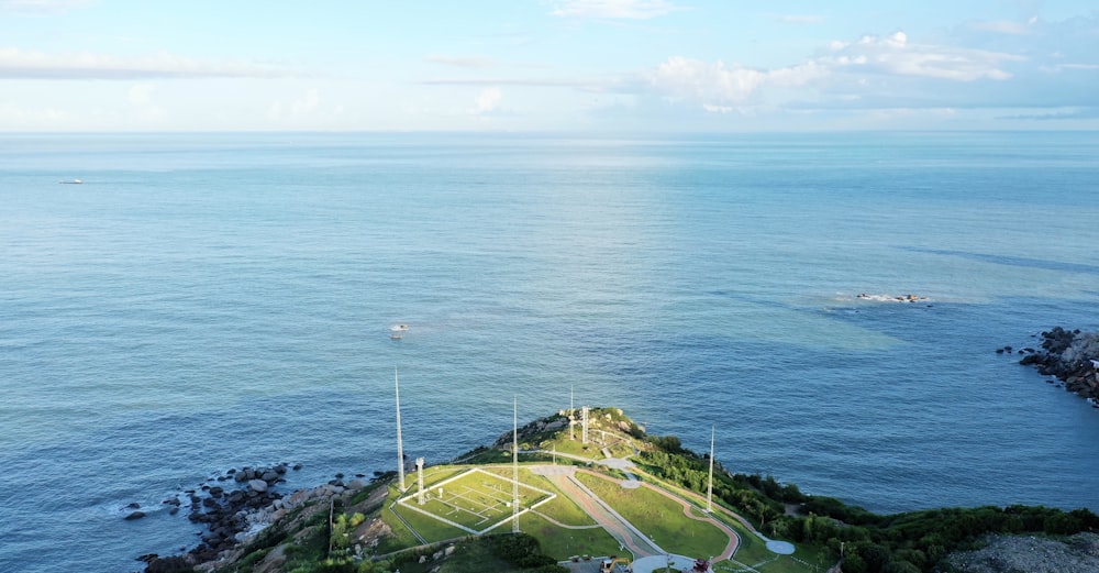 aerial view of green grass field near body of water during daytime