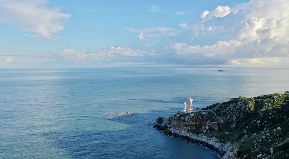 white and brown lighthouse on island during daytime