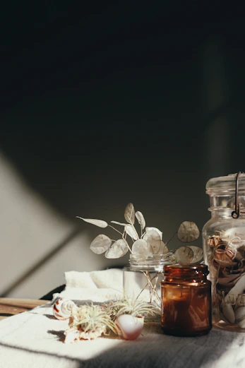 clear glass bottle on white textile
