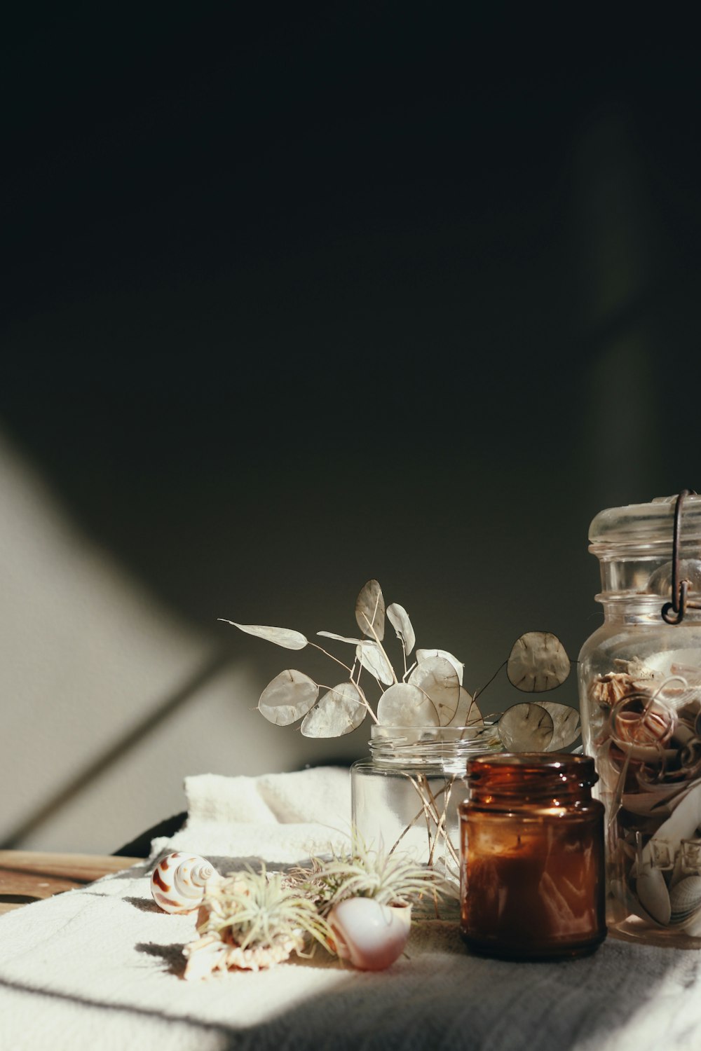 clear glass bottle on white textile