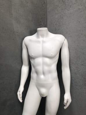 Side view of a man standing with perfect posture, the wearable discreet under his shirt.