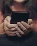 person holding black iphone 4