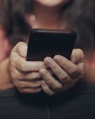 person holding black iphone 4