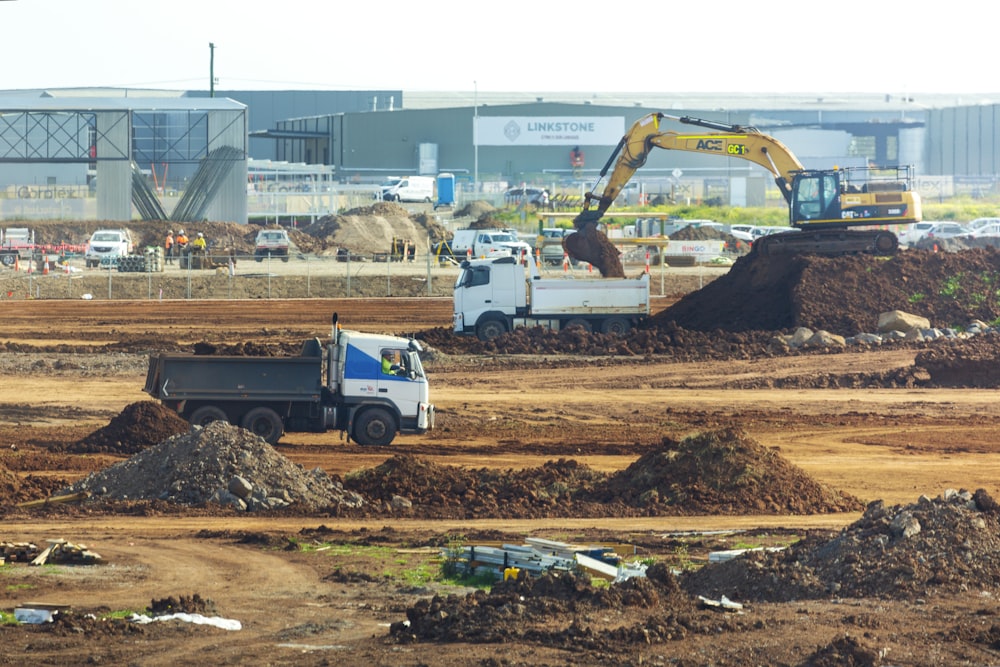 a construction site with a dump truck and a bulldozer