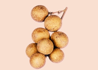 brown round fruit on white background