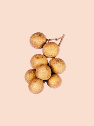 brown round fruit on white background