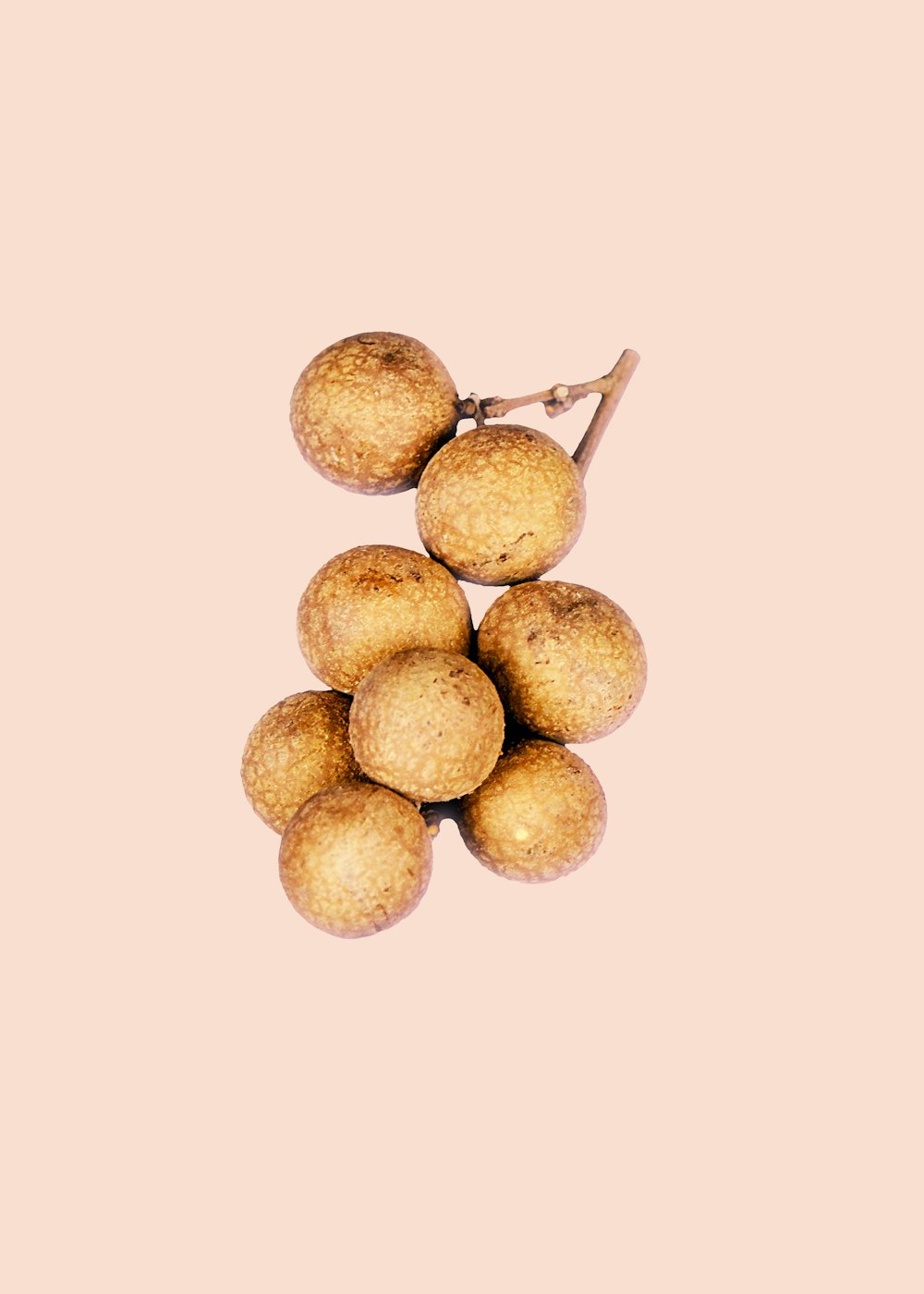 brown round fruit on white background