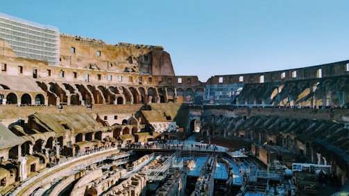 A gladiator arena filled with cheering crowds under a bright sky.