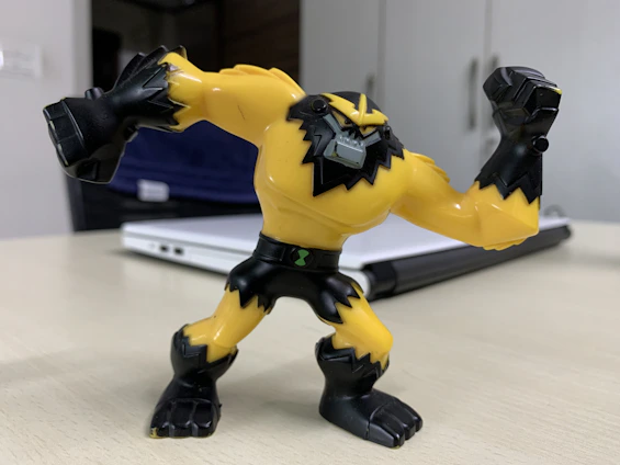 A vibrant 3D printed action figure posed dynamically on a sleek black stand.