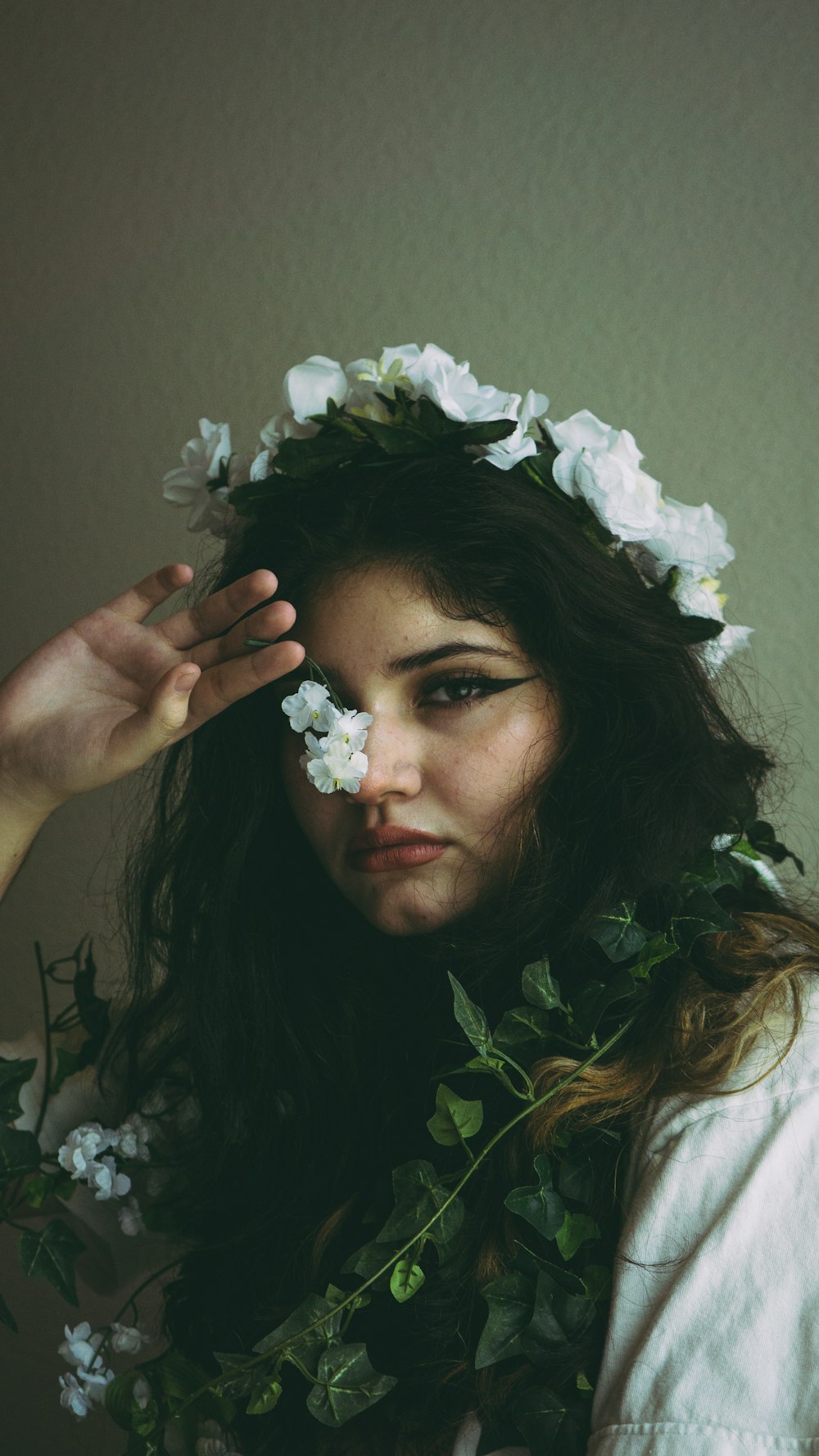 woman in white shirt with white flower on her ear