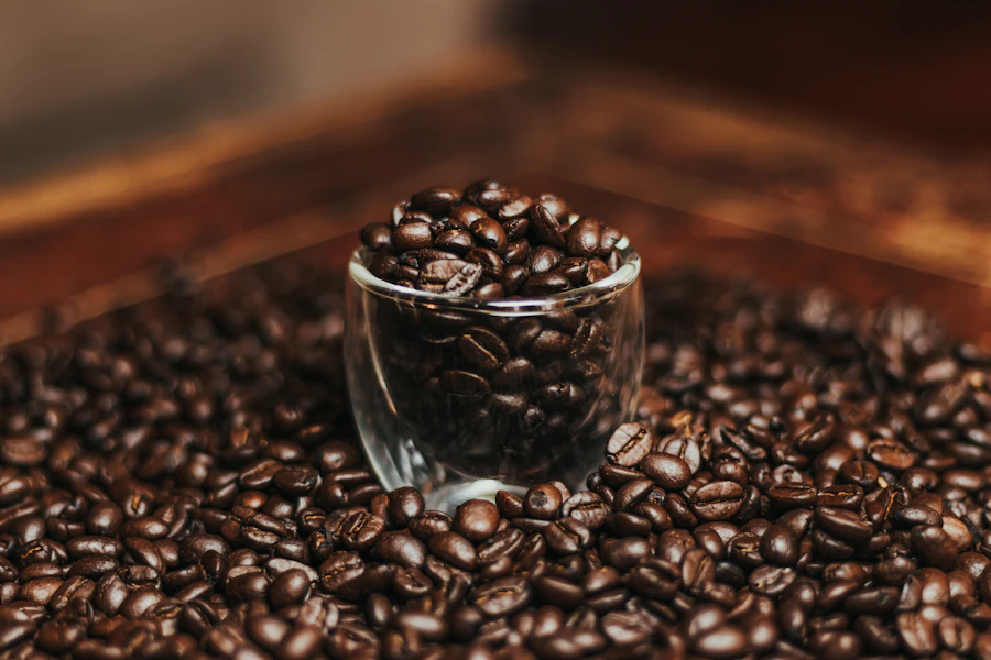 Roasted coffee beans held in a small glass cup