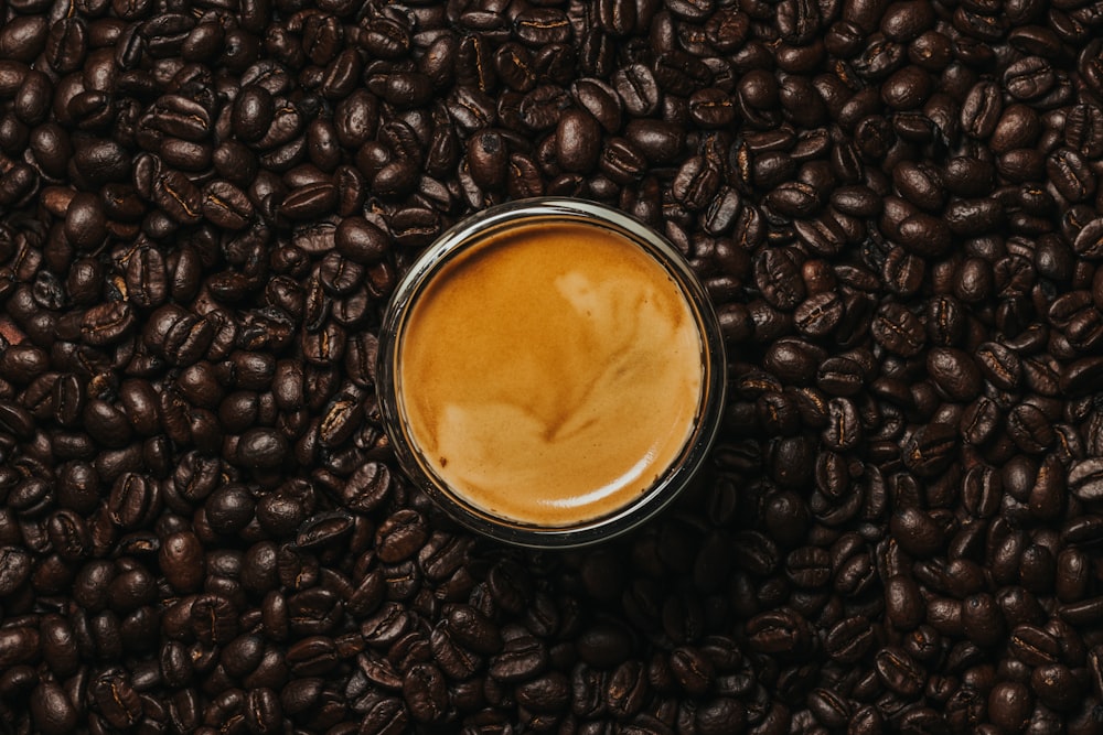 black coffee beans on white ceramic mug