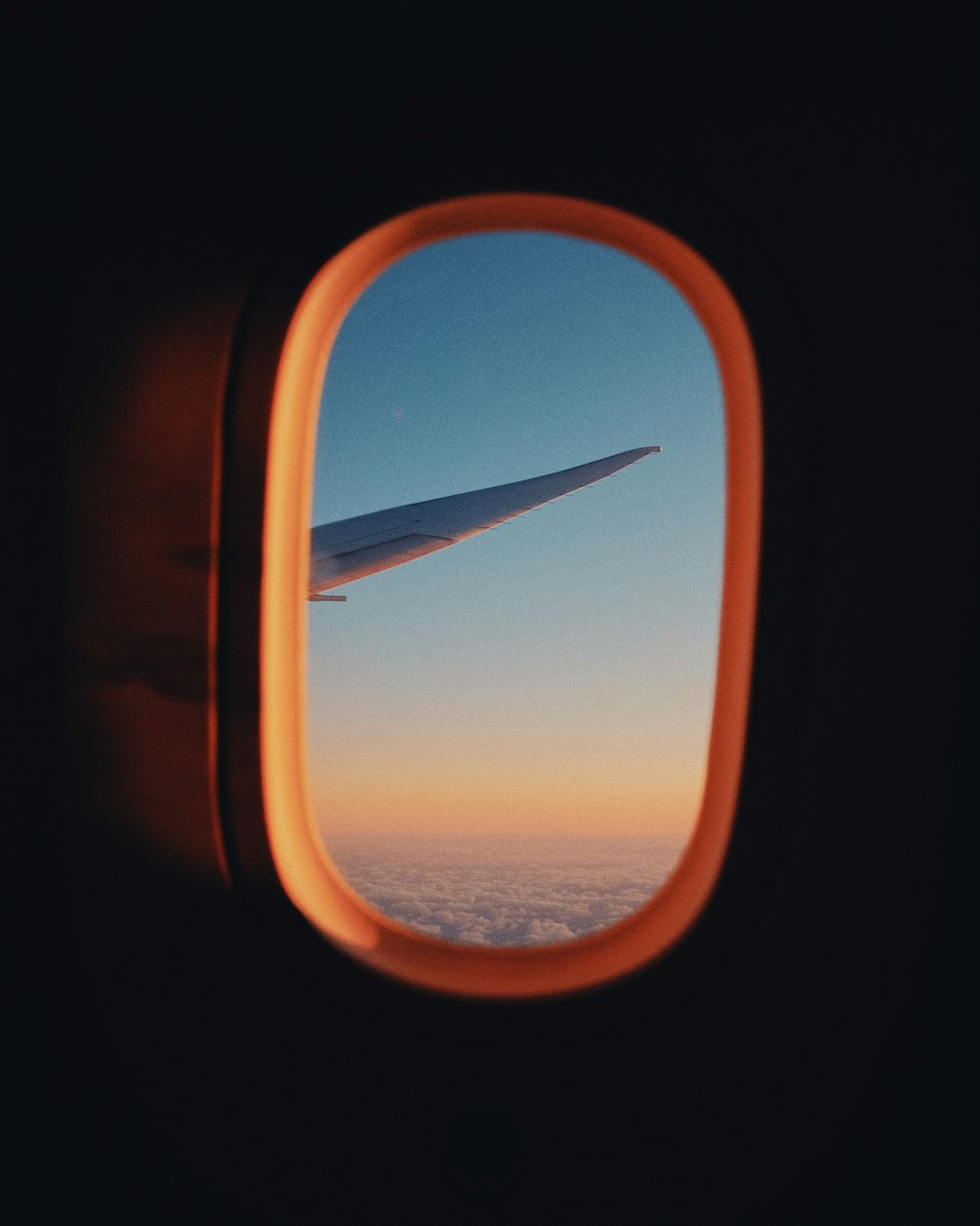 airplane window view of clouds during daytime