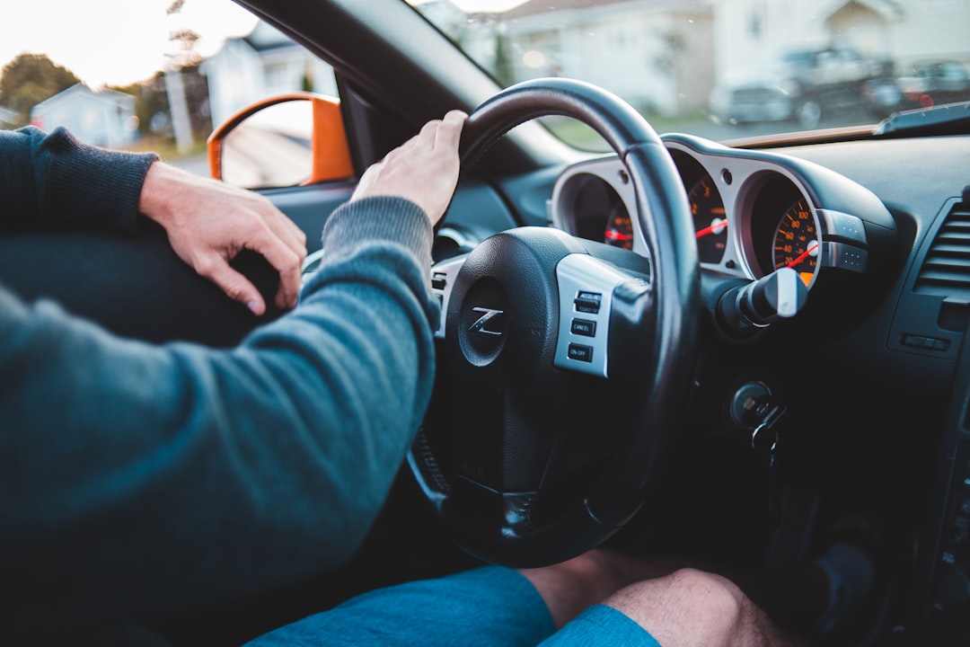 person in blue long sleeve shirt driving car