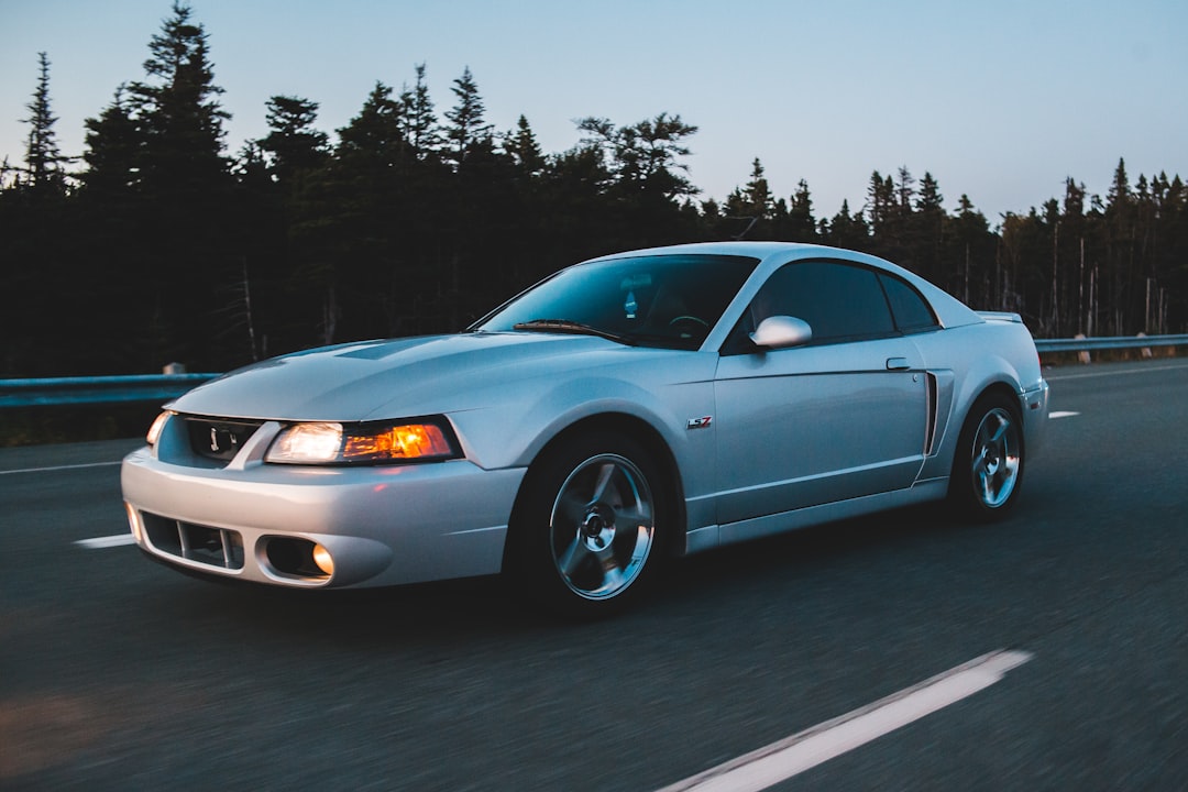 gray coupe on gray asphalt road during night time