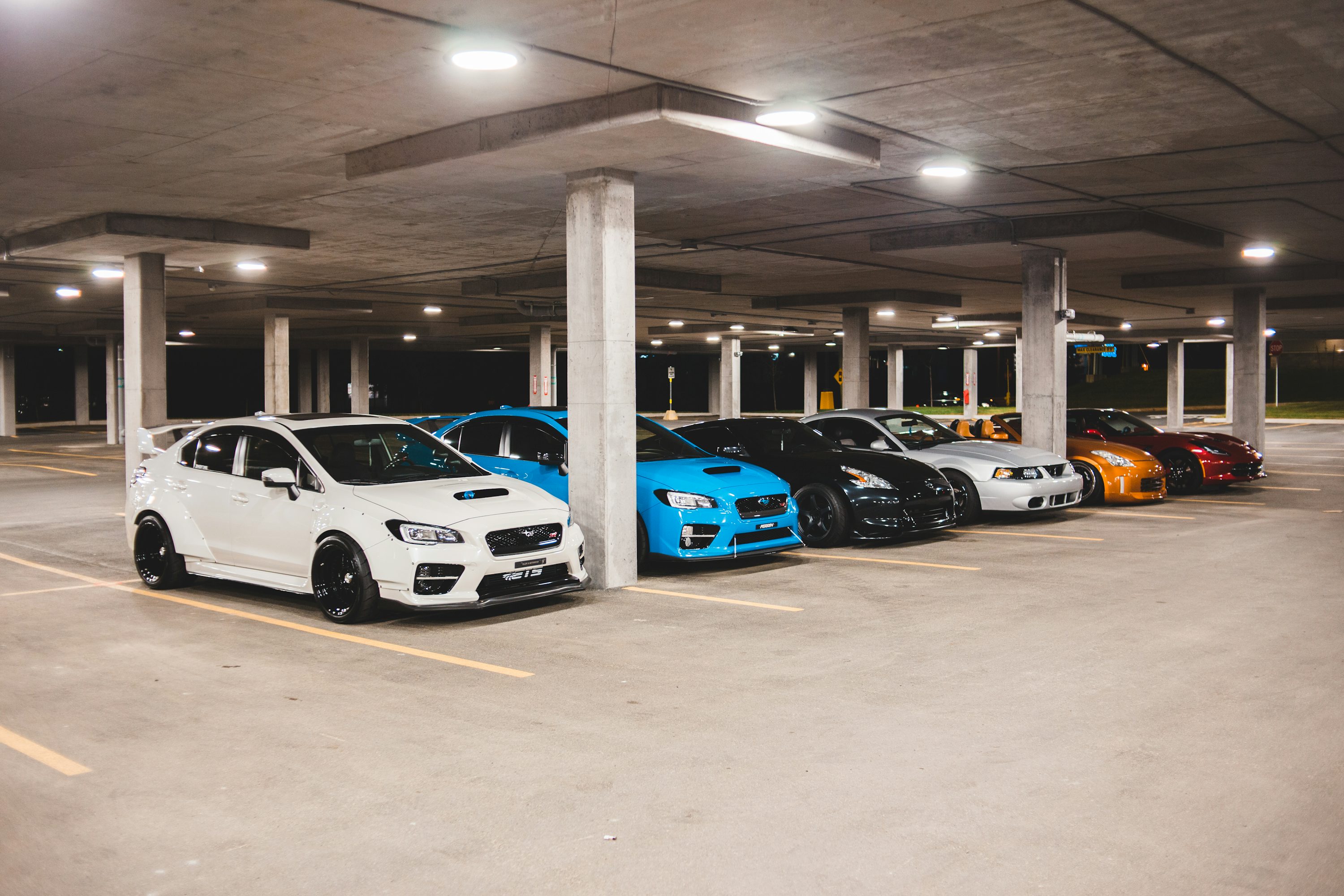 white and blue cars parked on parking lot