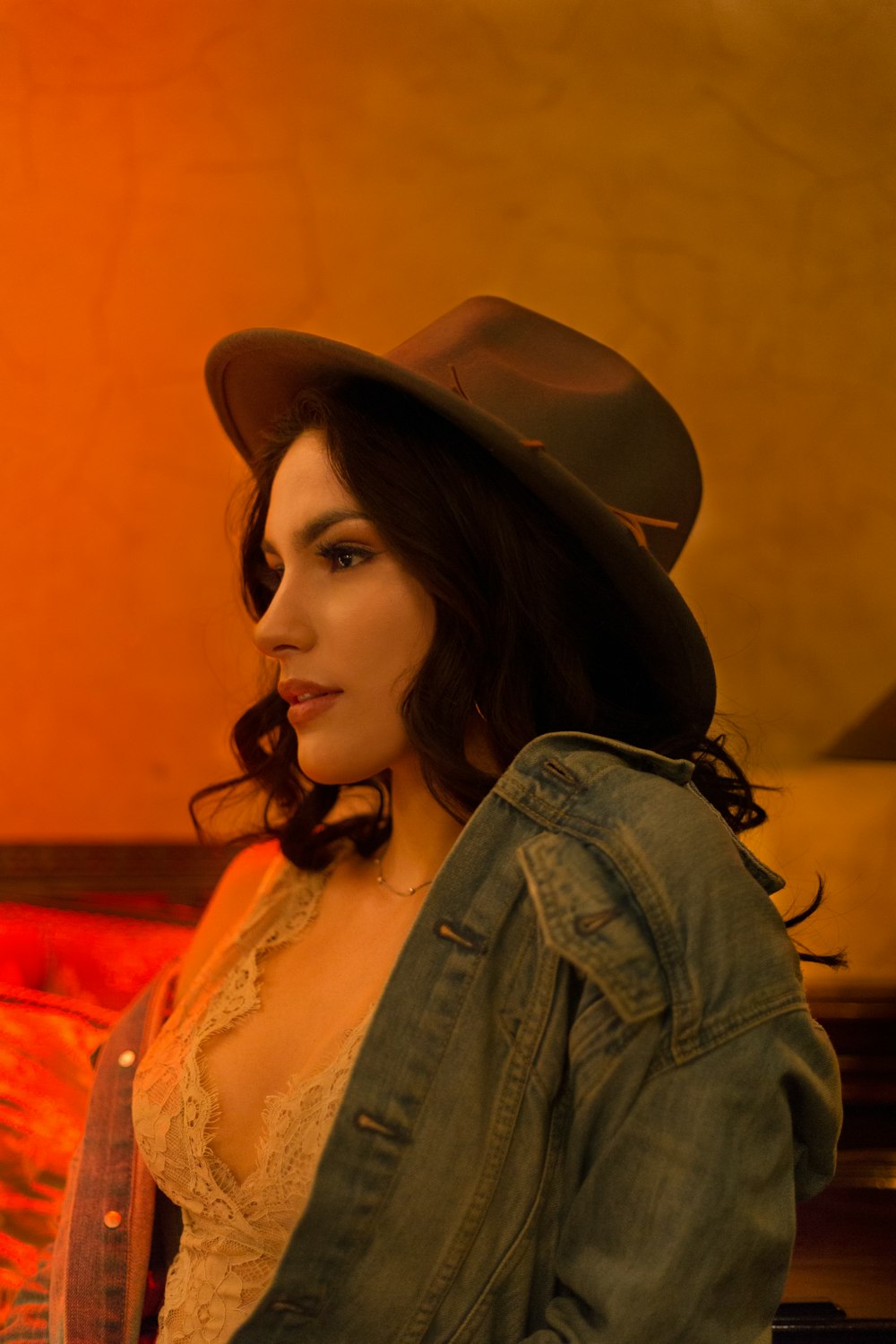 woman in blue denim jacket wearing brown hat