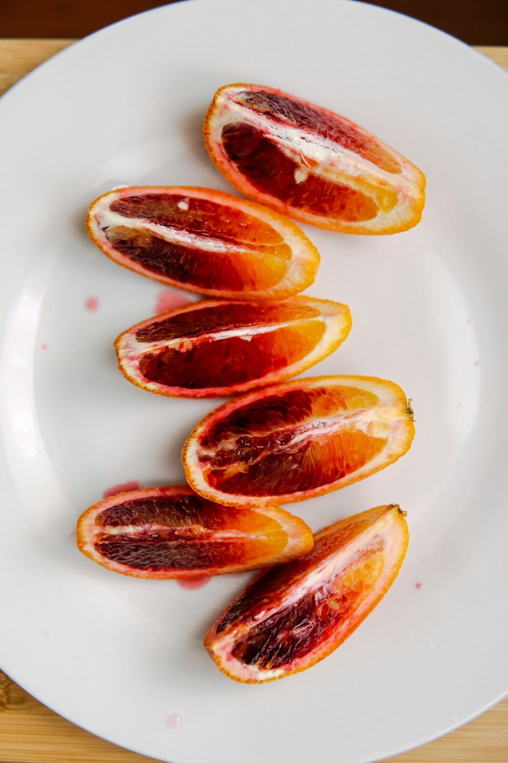 sliced orange fruit on white ceramic plate