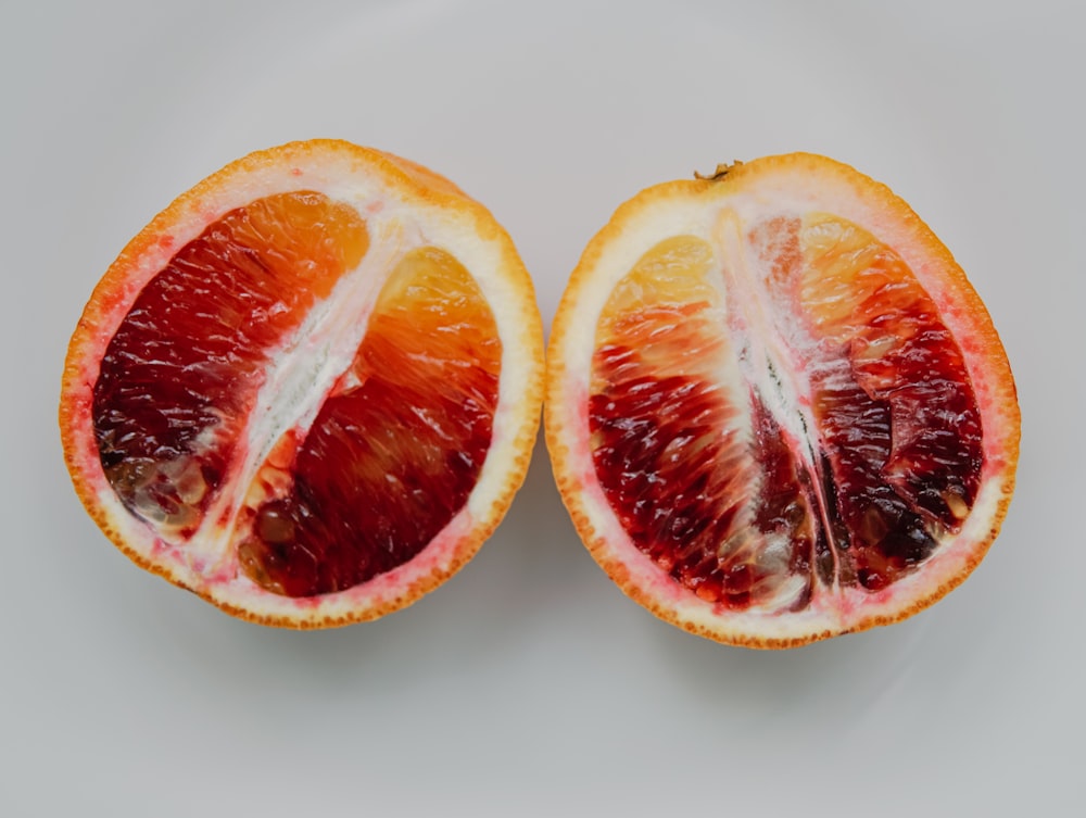 sliced orange fruit on white surface