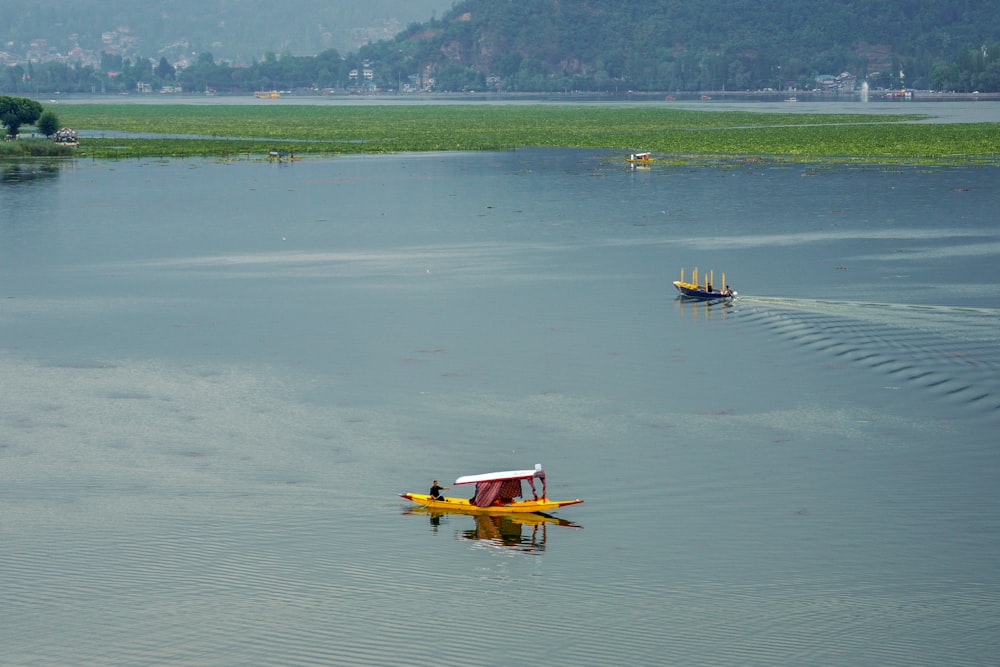 yellow and black boat on body of water during daytime