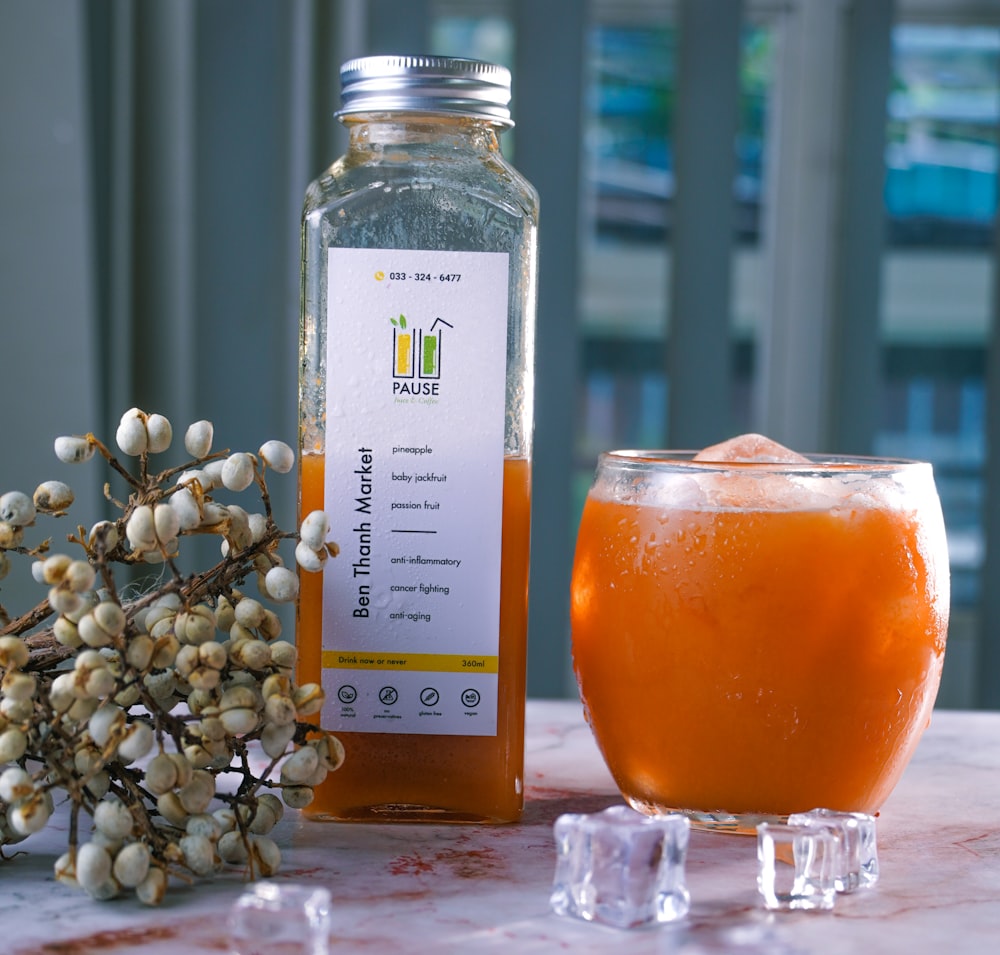 clear glass jar with orange liquid inside