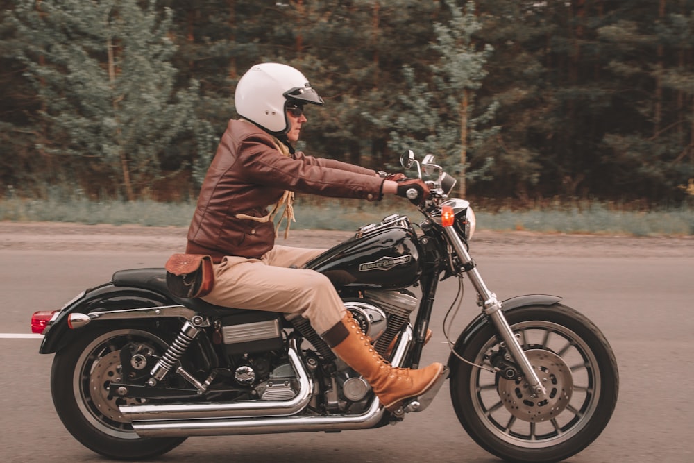 A rider wearing motorcycle gear, including helmet, jacket, gloves, and boots. Proper gear is ideal for rainy weather rides.