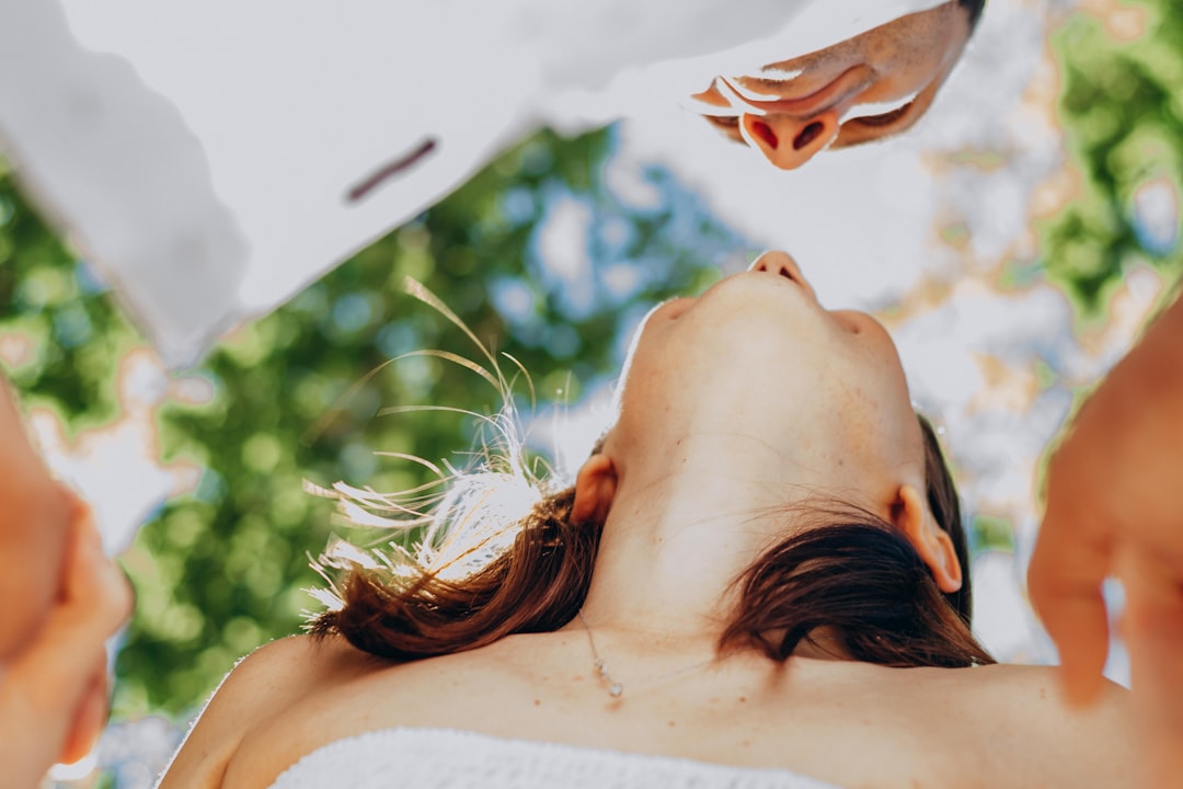 woman with brown hair covering her face with her hair