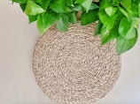 Woven jute table mats laid out on a wooden dining table with soft natural light.
