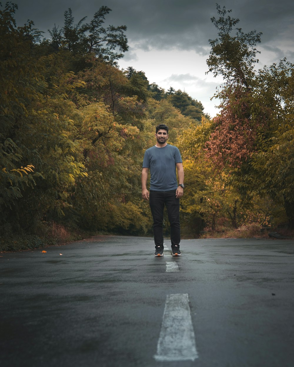 man in black jacket standing on road during daytime